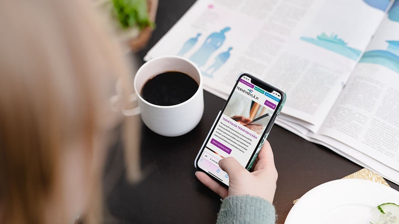 A hand holding a mobile phone with a health app