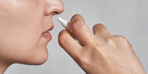 Woman using nasal spray